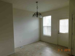 Fountain house for rent - A room with a chandelier and a window with blinds.