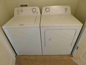 Fountain house for rent - Two white front loading washing machines in a small room.