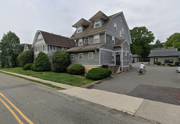 Montclair apartment for rent - a man riding a bike down a street in front of a house