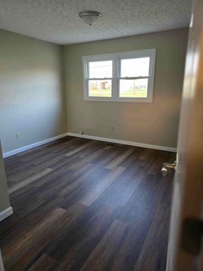 Ashland house for rent - an empty room with wooden floors and a window