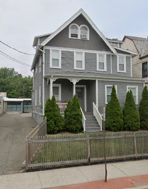 Montclair apartment for rent - A grey house with a white fence in front.