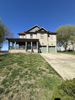 Clarksville house for rent - a large brick house with a driveway and a porch
