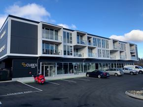 Courtenay apartment for rent - A parking lot in front of a building with the sign "CUBES".