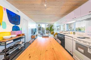 Courtenay apartment for rent - A modern kitchen with a wooden floor and a large painting on the wall.