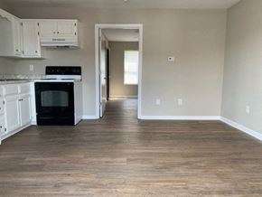 Richmond apartment for rent - A kitchen with a black oven and white cabinets.