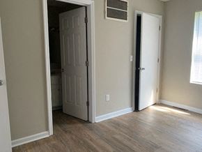 Richmond apartment for rent - A room with a white door and a window.