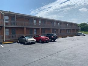 Richmond apartment for rent - A parking lot with cars and a building in the background.