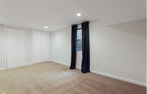 Washington apartment for rent - a bedroom with white walls and a window with black curtains