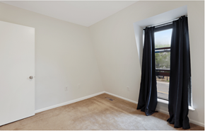Washington apartment for rent - a room with white walls and a window with black curtains