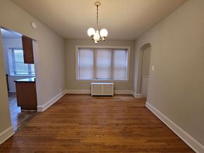 Chicago apartment for rent - a empty living room with a window and a radiator