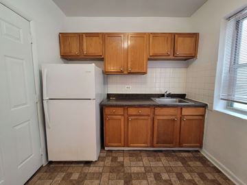 Chicago apartment for rent - a small kitchen with a refrigerator and a sink