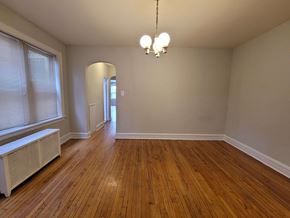 Chicago apartment for rent - a living room with wood floors and a large window