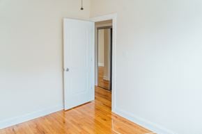 Chicago apartment for rent - an empty room with a door open to a hallway and a door to a bedroom
