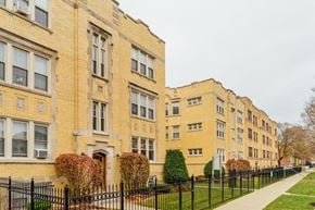 Chicago apartment for rent - a row of brick apartment buildings on a sidewalk