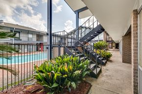 Lafayette apartment for rent - A pool area with a staircase and plants.