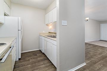 Lafayette apartment for rent - a kitchen with white cabinets and a white refrigerator