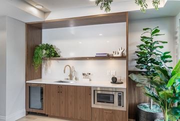 Vancouver apartment for rent - A modern kitchen with wooden cabinets and a glass shelf above the counter.
