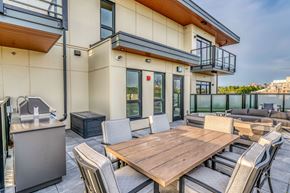 Vancouver apartment for rent - A modern outdoor dining area with a wooden table and chairs.