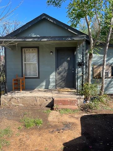 Oklahoma City house for rent - A small house with a grey siding and a white door.