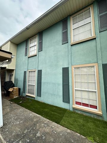 Lafayette house for rent - the side of a blue house with green shutters and grass