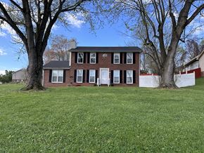 Clarksville house for rent - a brick house with two trees in front of it