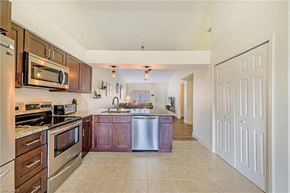 Bonita Springs house for rent - a large kitchen with stainless steel appliances and wooden cabinets