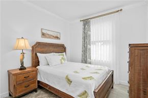 Estero house for rent - a bedroom with a bed and two dressers and a window