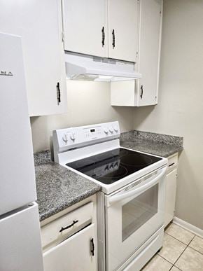 Broussard apartment for rent - a kitchen with white appliances and granite counter tops
