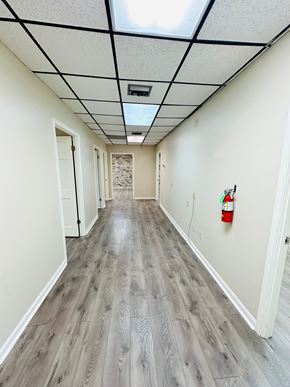 Lafayette apartment for rent - a hallway with white walls and wood flooring and a red fire hydrant on