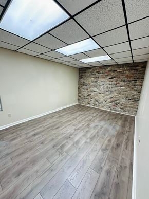 Lafayette apartment for rent - an empty room with wood floors and a brick wall