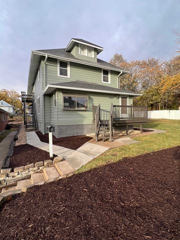 Omaha house for rent - A house with a grey roof and a grey wall with a white window.