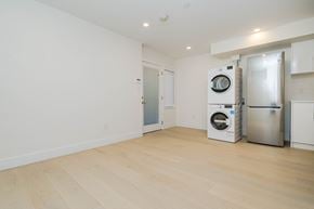Vancouver apartment for rent - a living room with a refrigerator and a washing machine