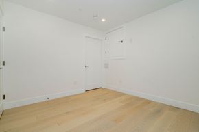 Vancouver apartment for rent - a bedroom with white walls and wood floors