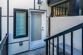 Vancouver apartment for rent - a door on the side of a building next to a staircase