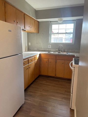 Lima house for rent - an empty kitchen with a refrigerator and a sink