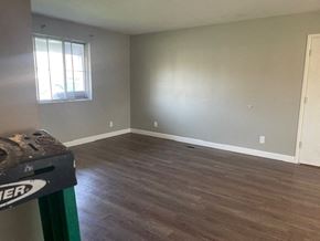 Lima house for rent - an empty living room with wood flooring and a window