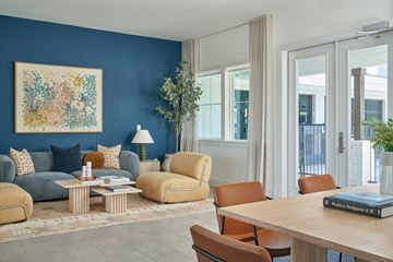 Leander apartment for rent - A living room with a blue wall and a painting on it.