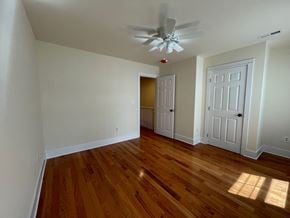 Angier house for rent - a living room with wood floors and a ceiling fan
