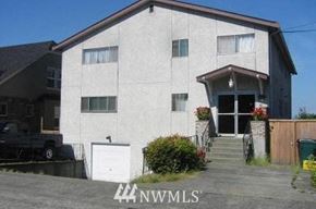 Seattle apartment for rent - a white house with a garage and a driveway