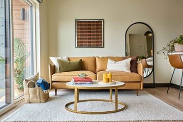 Missoula apartment for rent - A living room with a sofa, a coffee table, and a mirror.