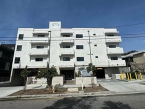 Los Angeles apartment for rent - A white building with a black railing in front of it.