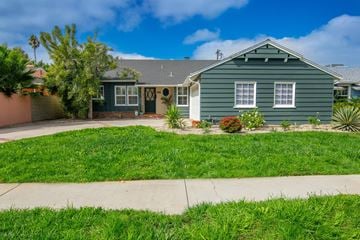 Los Angeles house for rent - A green house with a grey roof and a white door.