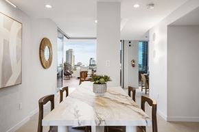 San Diego apartment for rent - A dining room with a long table and chairs.