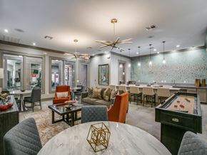 Houston apartment for rent - A modern dining room with a pool table and a bar area.