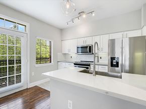 Houston apartment for rent - A kitchen with white cabinets and a white counter top.