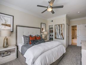 Houston apartment for rent - A bedroom with a large bed and a ceiling fan.