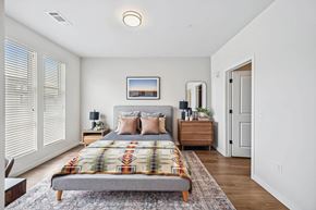 Denver apartment for rent - a bedroom with a bed and a closet