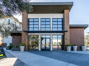 Pleasanton apartment for rent - The front of a building with a sign that says