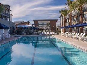 Pleasanton apartment for rent - A large swimming pool with a building in the background.