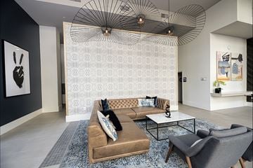 Mountain View apartment for rent - A living room with a brown couch and a patterned wallpaper.